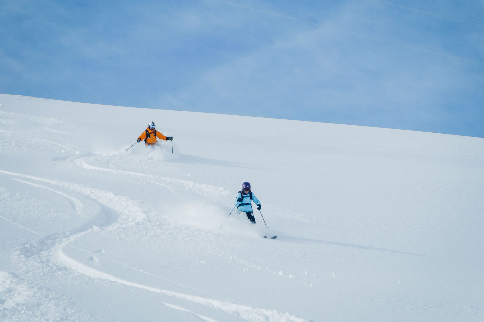 skiers making fresh tracks