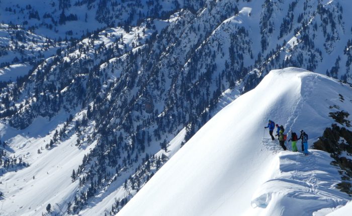 group of off piste skiers on mountain top